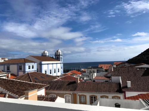 a view of a city with a church and roofs at City Center Apartment in Angra do Heroísmo