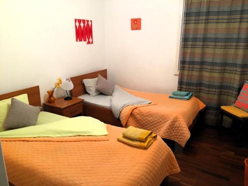 a room with two beds and a couch at City Center Apartment in Angra do Heroísmo