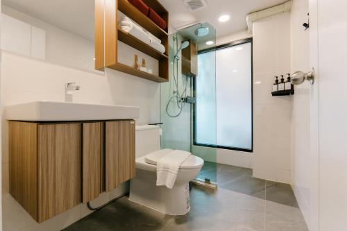 a bathroom with a toilet and a sink and a shower at Wangkaew Hotel, Phitsanulok in Phitsanulok