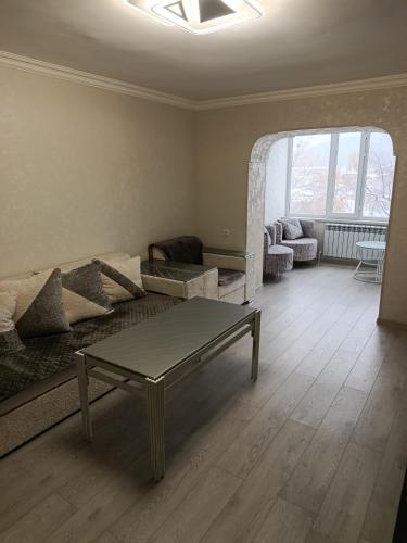 a living room with a couch and a table at Jermuk Calm House in Jermuk