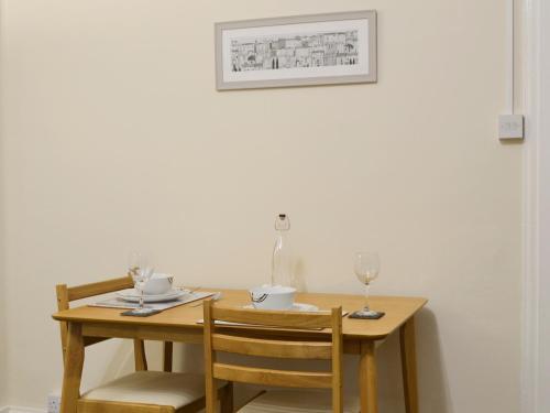 a dining room table with two chairs and a table with glasses at Bankfield - Uk5660 in Aberdeen