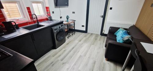 a kitchen with a sink and a washing machine at Modern Flat Close to Oxford City Centre in Oxford