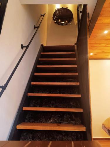 a set of stairs in a house with areath on the wall at Casa de Campo Huasca - Centro in Huasca de Ocampo