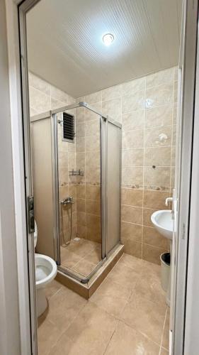 a bathroom with a shower and a toilet and a sink at otel efendi in Istanbul