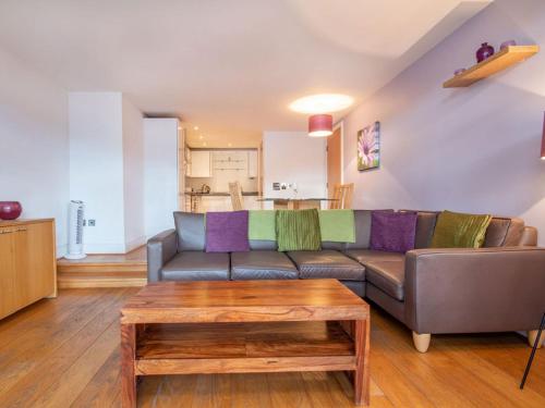 a living room with a couch and a coffee table at 206 By The Bridge Apartment in Inverness