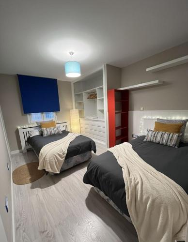 a bedroom with two beds and a blue light at Living Canovas in Alcalá de Henares