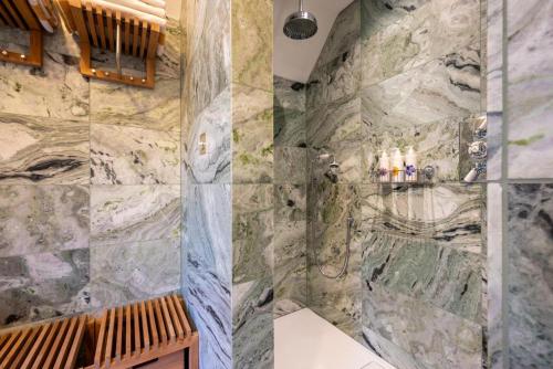 a bathroom with a large stone wall at 3 Bed in Ringsfield oc-m33329 in Wingfield