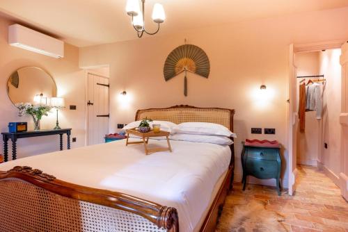 a bedroom with a large bed and a table at 3 Bed in Ringsfield oc-m33329 in Wingfield