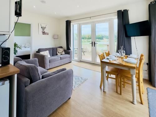 a living room with a table and a dining room at Deer Lodge - Ukc4325 in Pidley