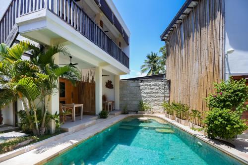 a swimming pool in the backyard of a house at Green Banana in Gili Trawangan