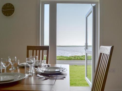 a dining room table with a view of the ocean at Rockworks Chalets No2 - Uk7041 in Saint Marys