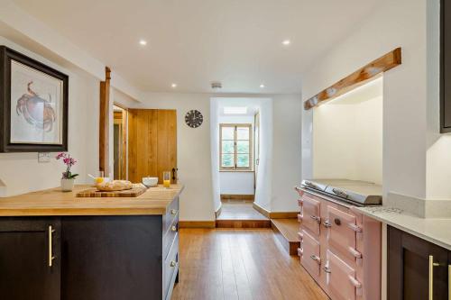 a kitchen with wooden floors and a counter top at 3 Bed in Croyde oc-s27761 in Croyde