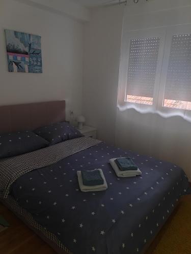 a bedroom with a bed with two plates on it at For You in Vrnjci