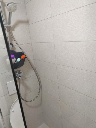 a shower in a bathroom with a shower head at For You in Vrnjci