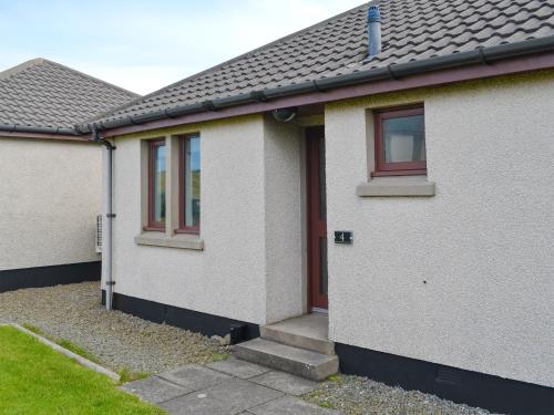 a white house with a red door and windows at Rockworks Chalets No4 - Uk7043 in Saint Marys
