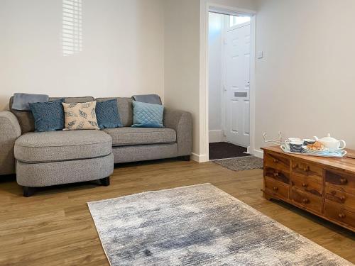 a living room with a couch and a coffee table at April House in Amble