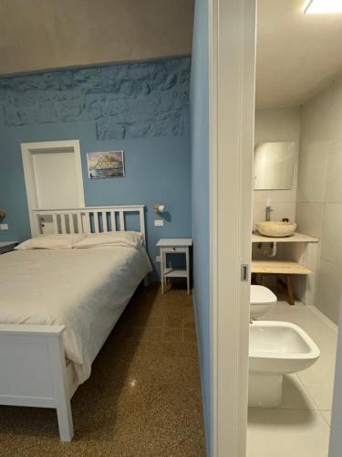 a bedroom with a bed and a tub and a sink at Il Panorama di Ercole in Monte di Procida