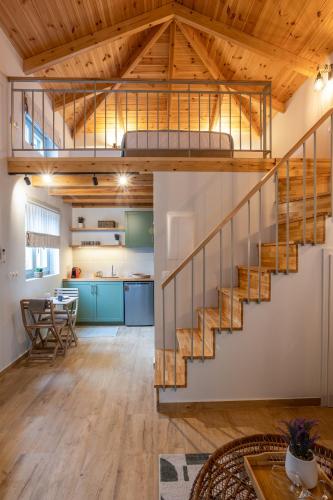 a loft conversion with a staircase and a kitchen at Pavliani Aesthesis by Raise in Pavliani