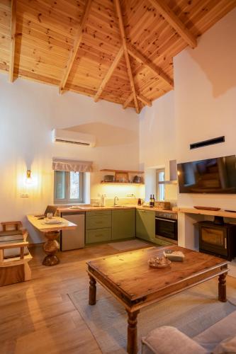 a large kitchen with a wooden table in a room at Pavliani Aesthesis by Raise in Pavliani