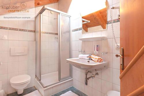 a bathroom with a shower and a sink and a toilet at Edelweißhof in Ischgl