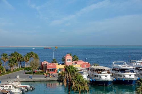 a group of boats docked in a harbor at AJIRA Bay Hotel Hurghada Marina in Hurghada