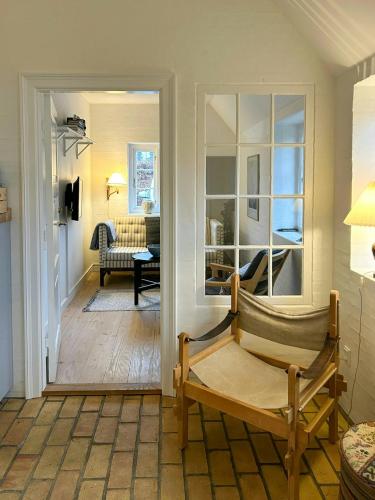 a room with a chair and a living room at Idyllic House By Mossø in Skanderborg