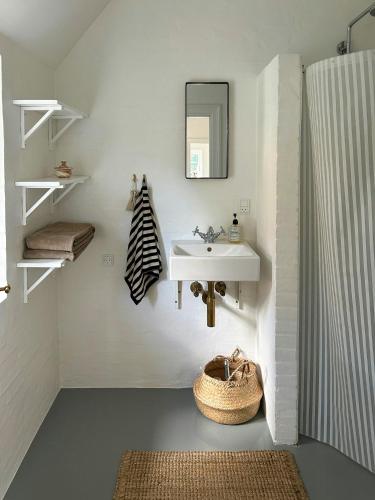 a bathroom with a sink and a mirror at Idyllic House By Mossø in Skanderborg