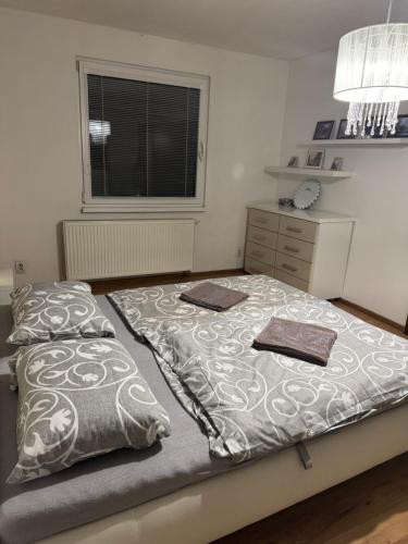 a bedroom with two beds and a window at Apartman Zvolen in Zvolen