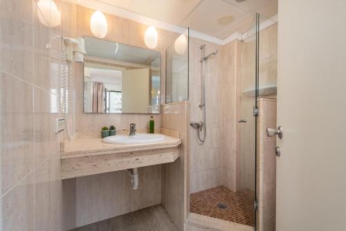 a bathroom with a sink and a shower at Apartamentos Playa Marina in Cala Ferrera