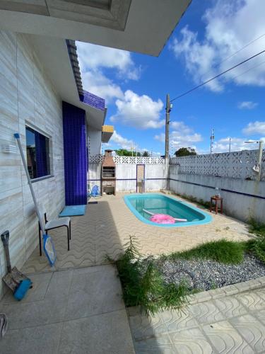 a swimming pool in the backyard of a house at Suíte na praia do amor in Conde