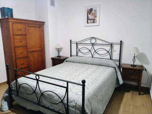 a bedroom with a black bed and a dresser at Casa " El Chacho " Velefique in Velefique