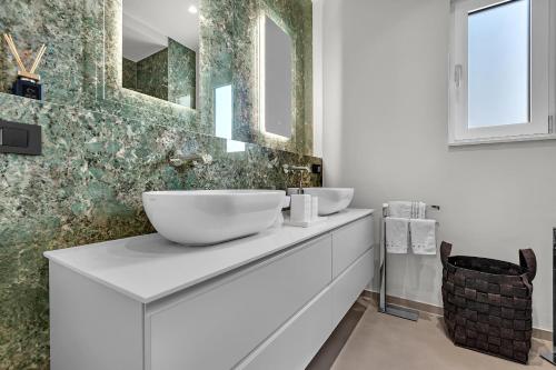 a white bathroom with two sinks and a mirror at Apartment Adriatic Pearl -Makarska Exklusiv in Tučepi