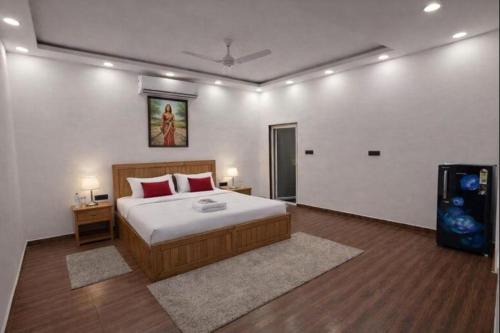 a bedroom with a bed and a television in it at Mud Meadows Peace and Tranquility Farm With Pool in Faridabad