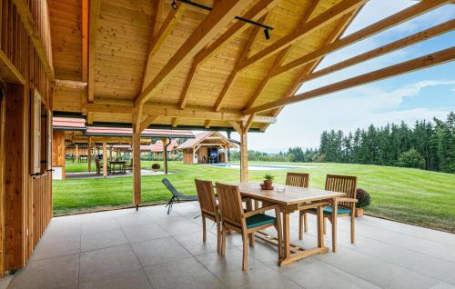 a wooden patio with a wooden table and chairs at Chalet In Stainz in Stainz
