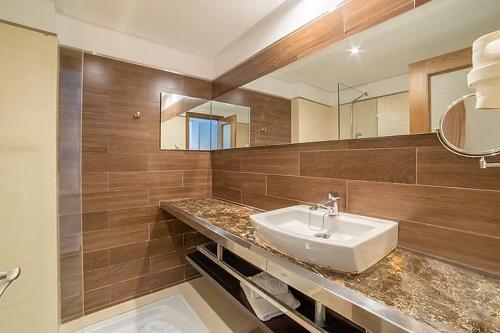 a bathroom with a sink and a mirror at FERGUS Club Font de Sa Cala Beach in Capdepera