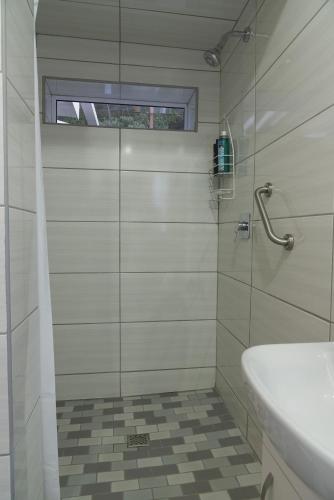 a bathroom with a shower and a sink at Naval Hill Nook in Bloemfontein