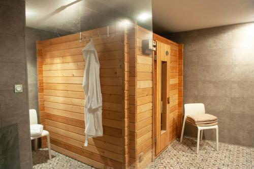 a bathroom with a wooden wall with a towel on it at Domaine de la Bedosse in Alès