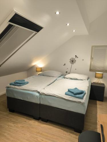 a bedroom with a large bed in a attic at Helle Wohnung mit zwei Schlafzimmern in Eching