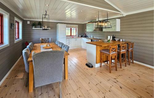 a kitchen and dining room with a wooden table and chairs at Gorgeous Home In Eggedal With Sauna in Eggedal