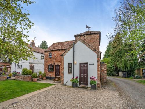 an exterior view of a house with a driveway at The Granary - 16437 in York