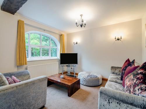 a living room with two couches and a tv at The Granary - 16437 in York