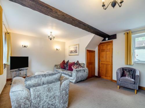 a living room with two couches and a tv at The Granary - 16437 in York
