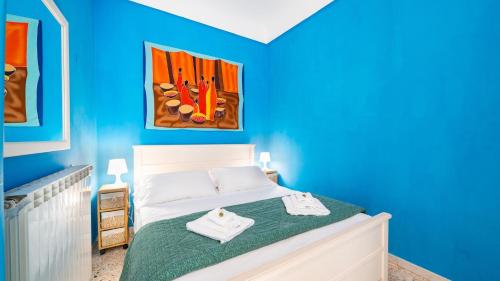 a blue bedroom with a bed with towels on it at Casa Zefiro by Rentbeat in Ostuni