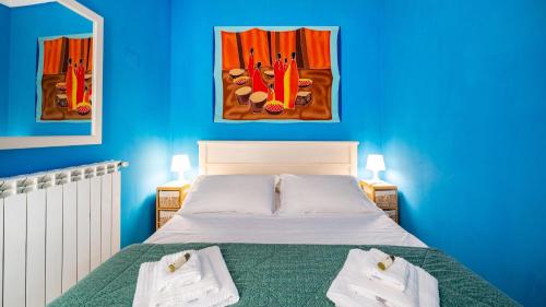 a blue bedroom with a bed with towels on it at Casa Zefiro by Rentbeat in Ostuni