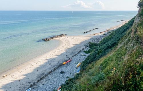 a beach with a group of kayaks on the shore at Amazing Home In Hundested With Wifi in Hundested