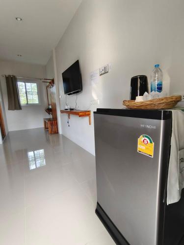 a kitchen with a refrigerator with a sign on it at Chiang Khan Dwelling in Chiang Khan