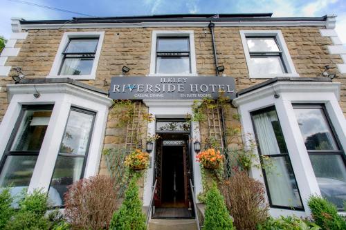 a building with a sign that reads riverside hotel at Ilkley Riverside Hotel in Ilkley