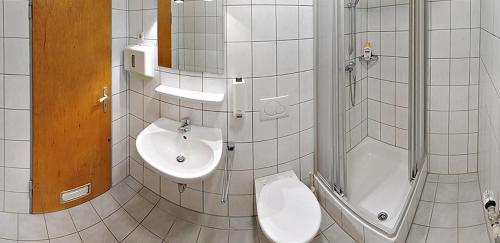 a bathroom with a toilet and a sink at Pension Keinath in Stuttgart