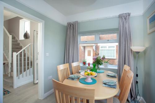 a dining room with a table and chairs and a window at Seymour House in Exmouth