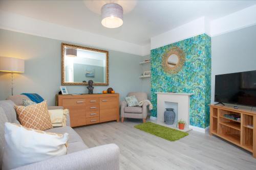 a living room with a couch and a fireplace at Seymour House in Exmouth